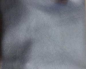 Veg tanned, natural milled grain Goat leather.  Very subtle hand tipped grain, 