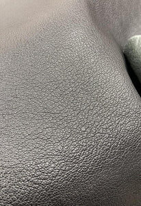 Veg tanned, natural milled grain Goat leather.  Very subtle hand tipped grain, 
